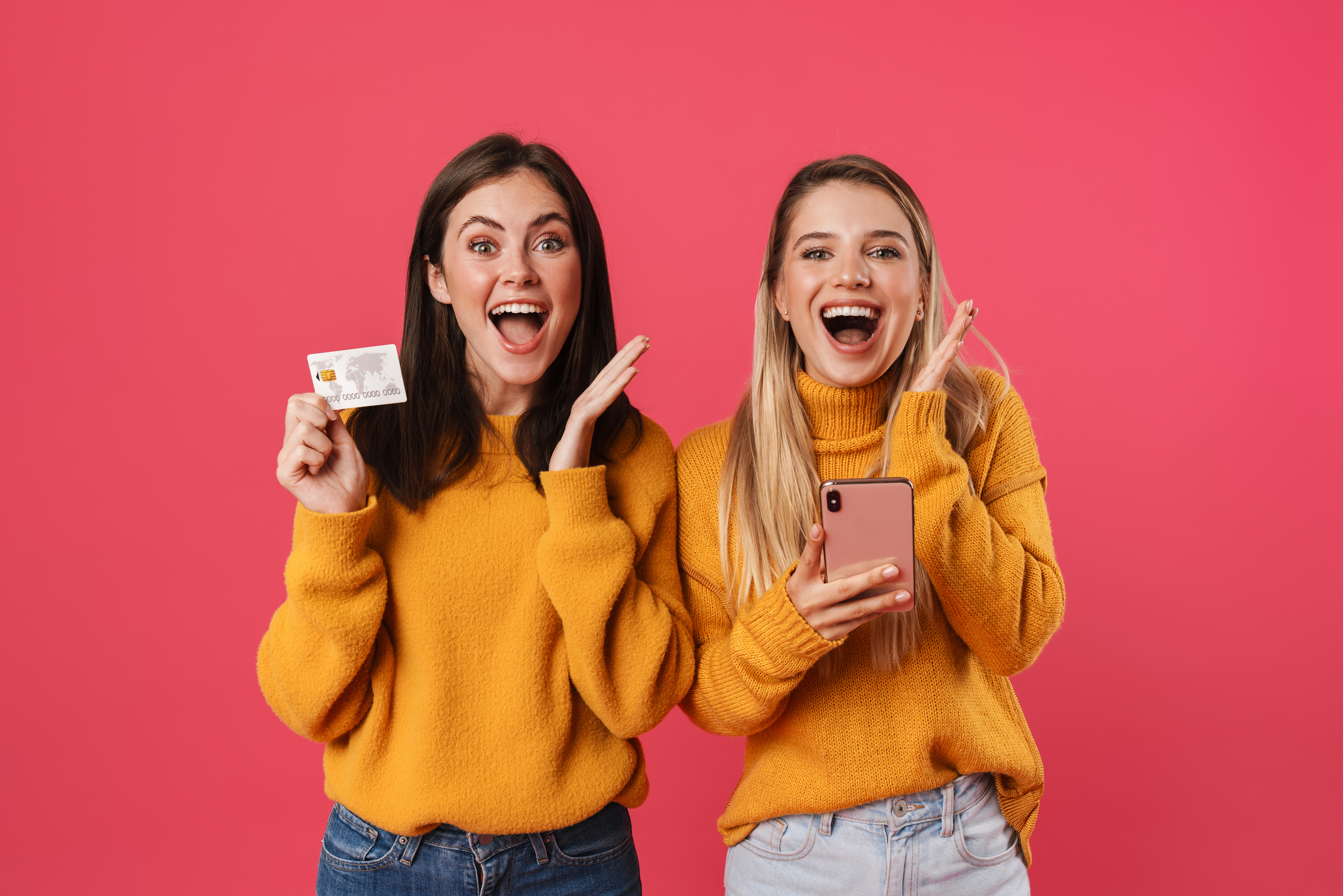 Two Happy Young Girlfriends Shopping Online